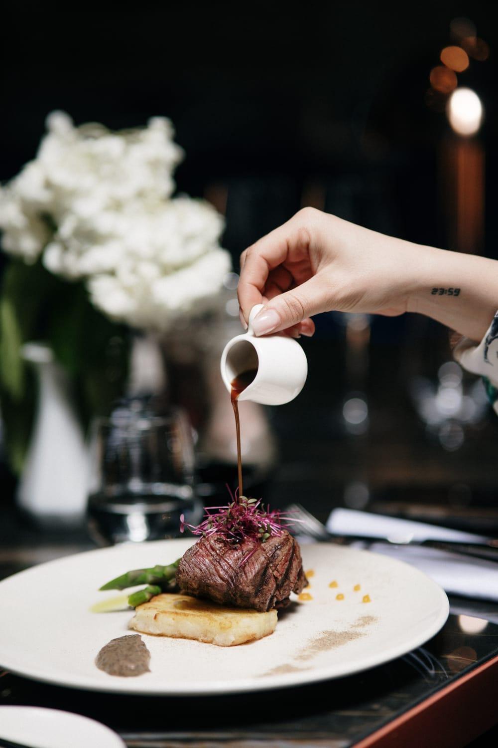 Xheko Imperial Luxury Hotel & Spa 티라나 외부 사진 A server pours soy sauce onto a dish